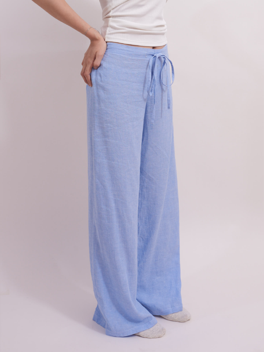 Side view of soft baby blue slim-fit linen lounge pants, showcasing flowy, breathable fabric and smart, relaxed fit.