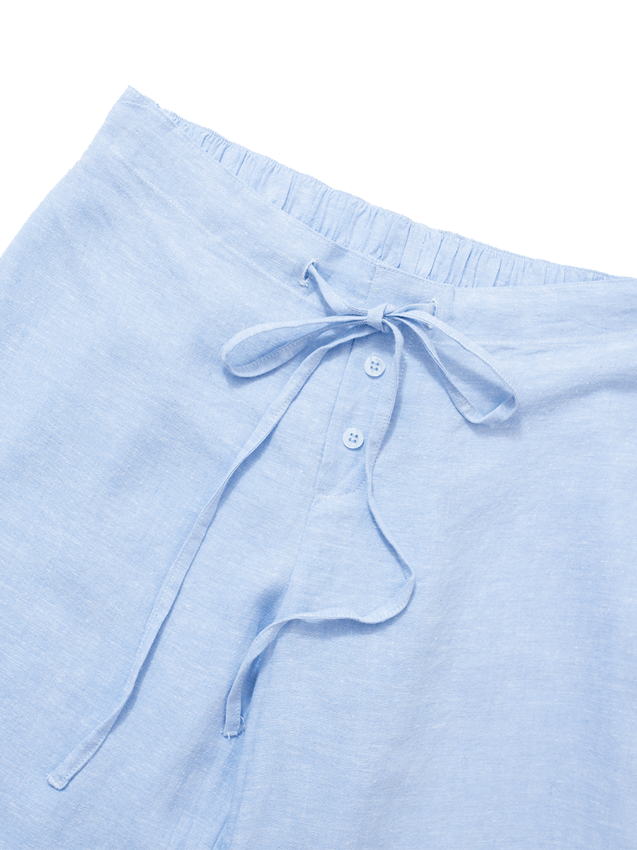 Drawstring, mock-fly with buttons detail on baby blue slim-fit linen lounge pants, combining smart style with functional comfort.