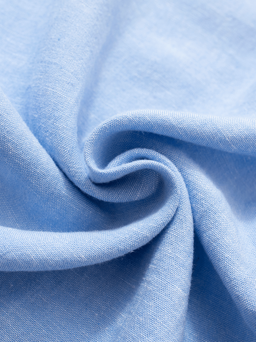 Close-up of soft baby blue slim-fit linen fabric, highlighting breathable texture for a smart, comfortable fit while working from home.
