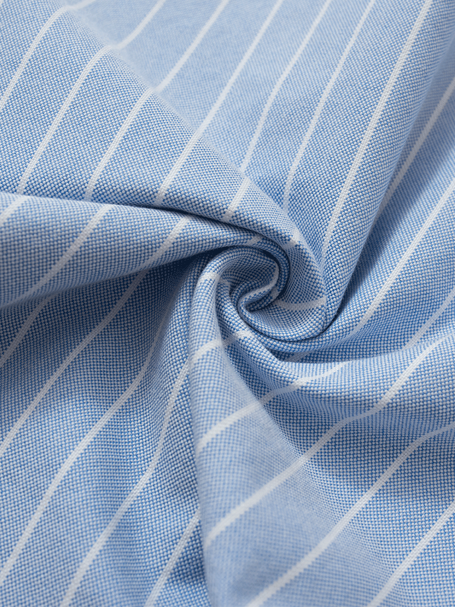 Close-up view of the thick, full-bodied 100% cotton Oxford fabric with blue and white pinstripes, showing the fabric texture and weave.