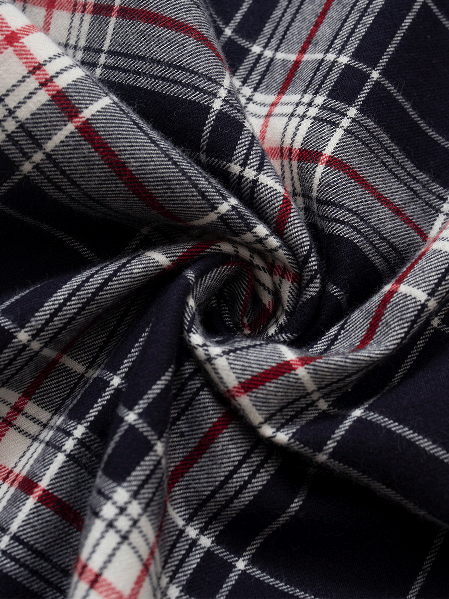 Close-up of the deep navy and rich red plaid tartan fabric in 100% brushed cotton flannel, showing the texture and pattern used in these low-rise wide leg lounge pants.