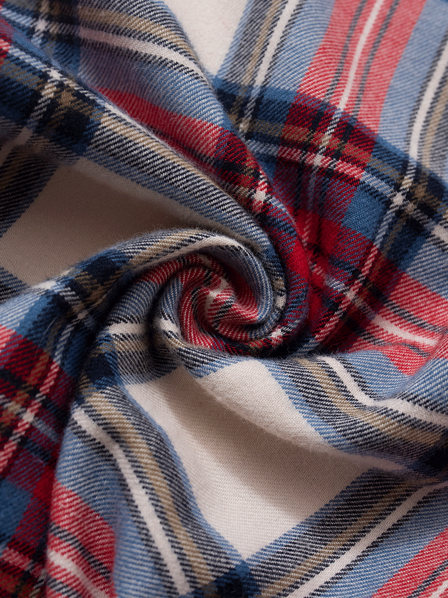 Close-up of the brushed cotton flannel fabric in red and cream plaid tartan, showing the texture and pattern used in these low-rise lounge pants.
