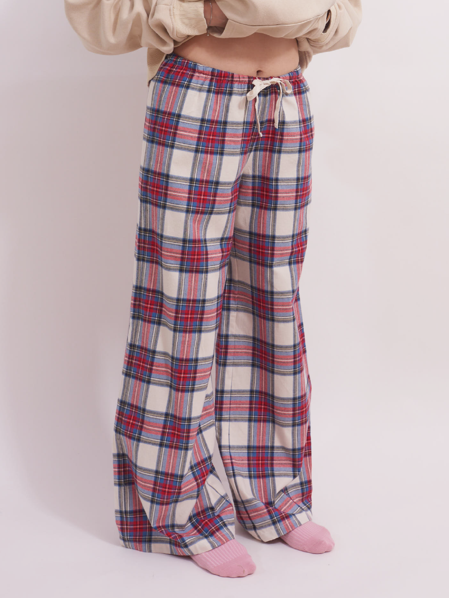 Front waist detail of low-rise wide leg lounge pants in red and cream plaid tartan, featuring a drawstring and elastic waistband for a comfortable fit, crafted from 100% brushed cotton flannel.