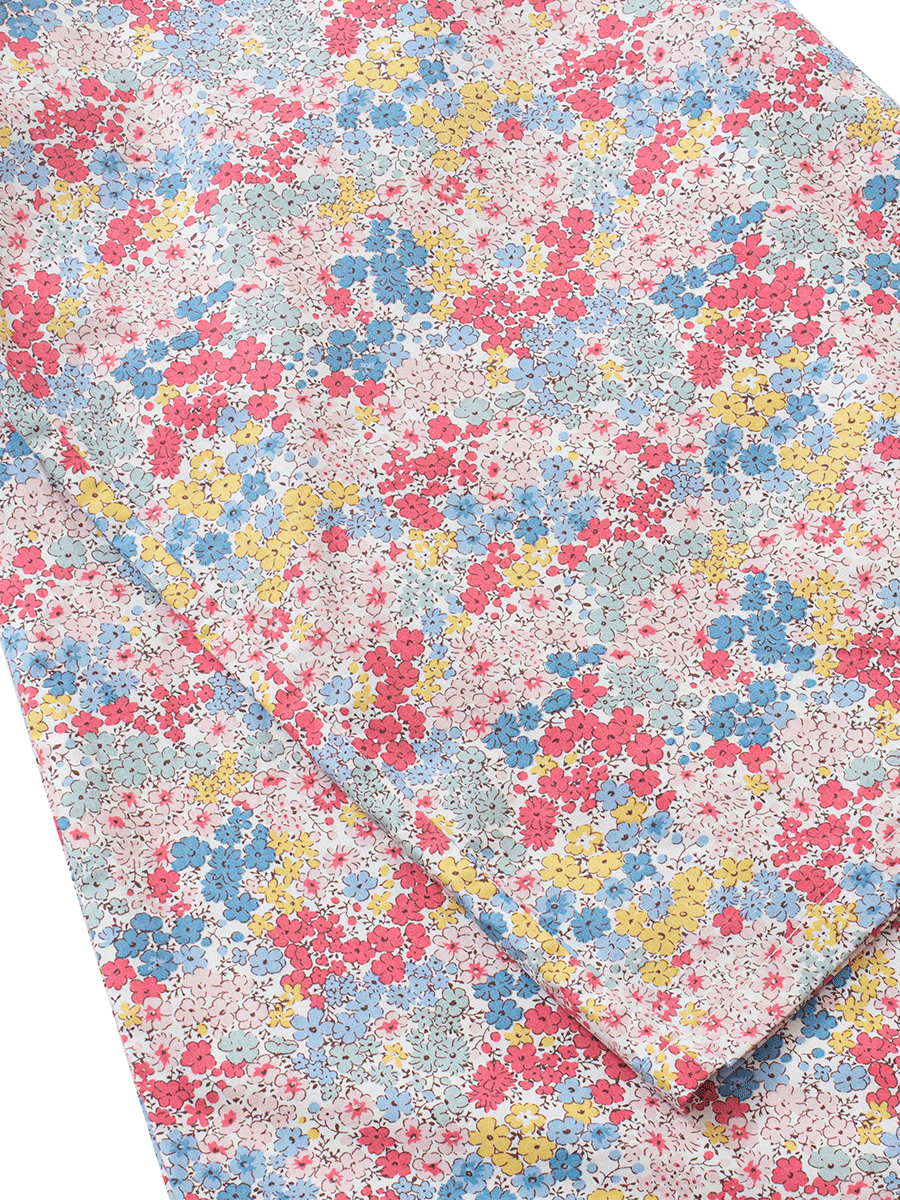 Close-up of the hemline on low-rise wide leg lounge pants in pastel pink ditsy floral print, highlighting the fine stitching and soft, lightweight 100% cotton poplin fabric.