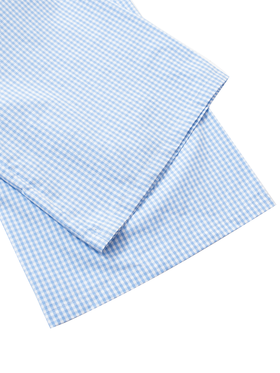 Close-up of the hem detail on the blue gingham mid-rise slim fit wide leg lounge pants, showing the clean finish and wide leg cut.