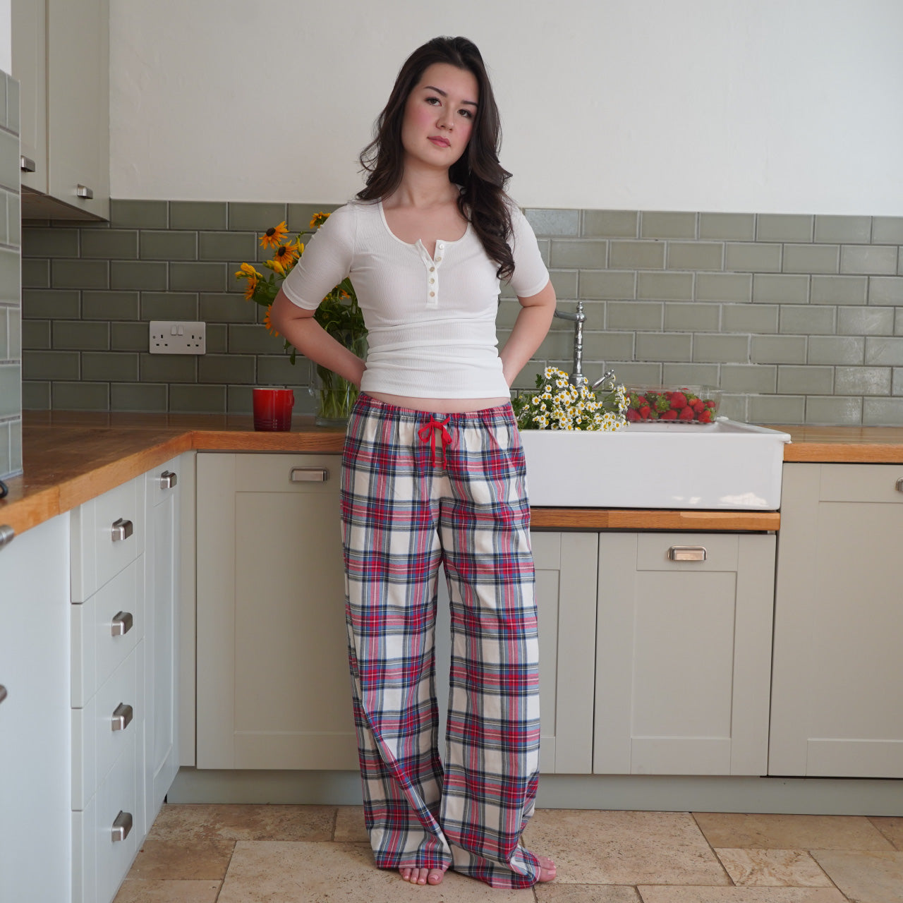 Red and cream plaid wide-leg lounge pants with a low-rise waist and adjustable drawstring, adding a cozy touch.