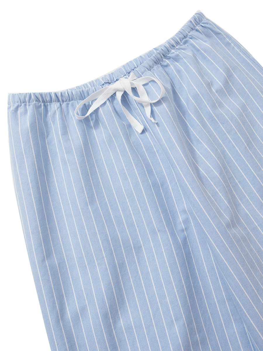 Waist detail of low-rise wide-leg lounge pants in blue pinstripes, made from thick 100% cotton Oxford fabric with an elasticated waistband and white drawstring.