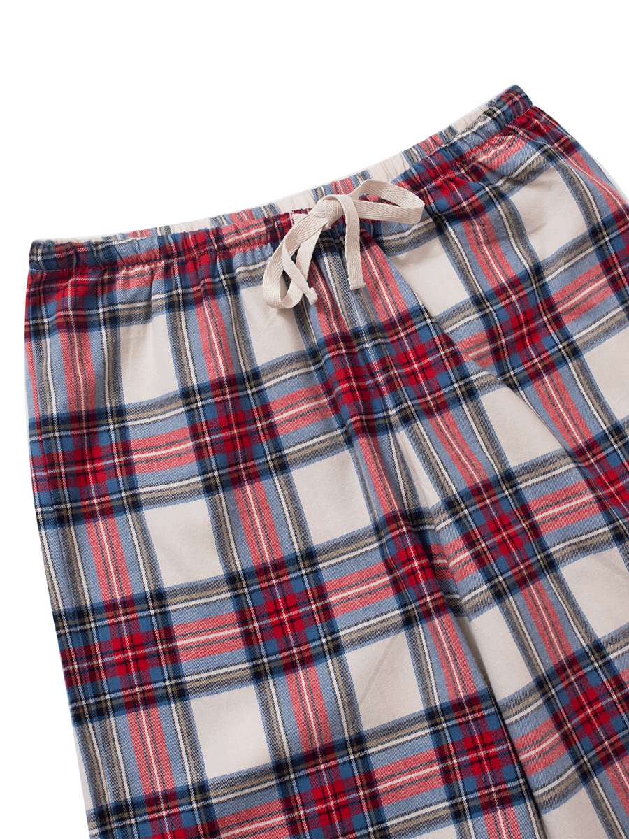 Waistband detail of low-rise wide leg lounge pants in red and cream plaid tartan, featuring an adjustable drawstring and elastic waistband, made from cozy brushed cotton flannel.