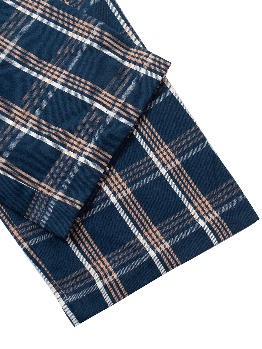 Close-up of blue plaid tartan brushed cotton fabric, ideal for warm winter pyjamas.