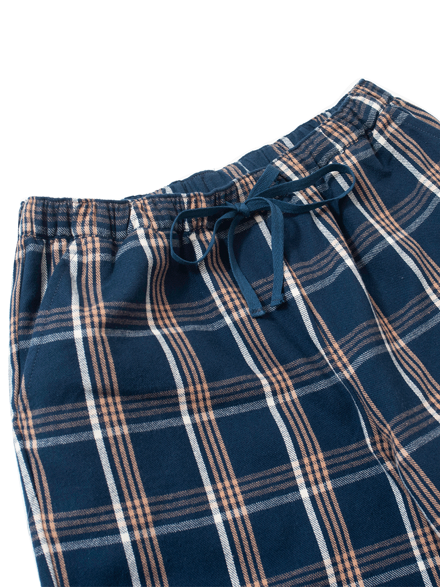 Waistband with drawstring on blue plaid brushed cotton pyjama bottoms, with pockets for winter wear.
