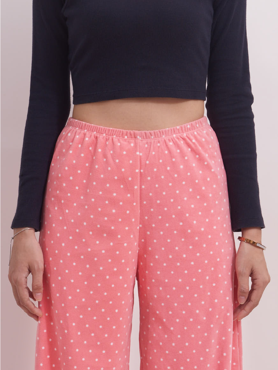 Front view of high-rise pink polka dot fleece lounge pants, wide leg and cosy for winter.