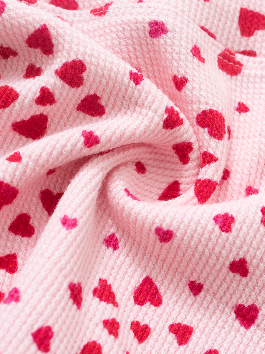 Texture of pink heart print waffle fabric in close-up