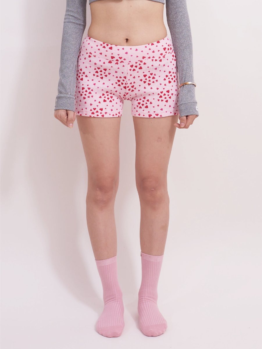 Front view of pink heart print waffle shorts with elastic waistband
