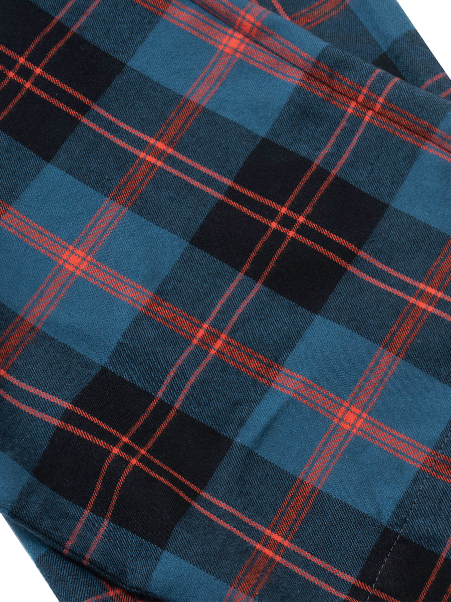 Hem of royal blue plaid pyjama bottoms in warm brushed cotton.