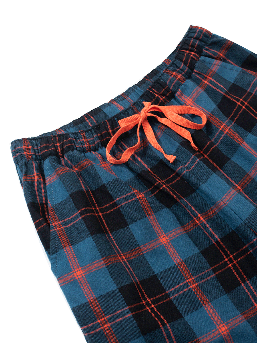 Elastic waistband with orange drawstring and pocket details on royal blue brushed cotton pyjama bottoms.