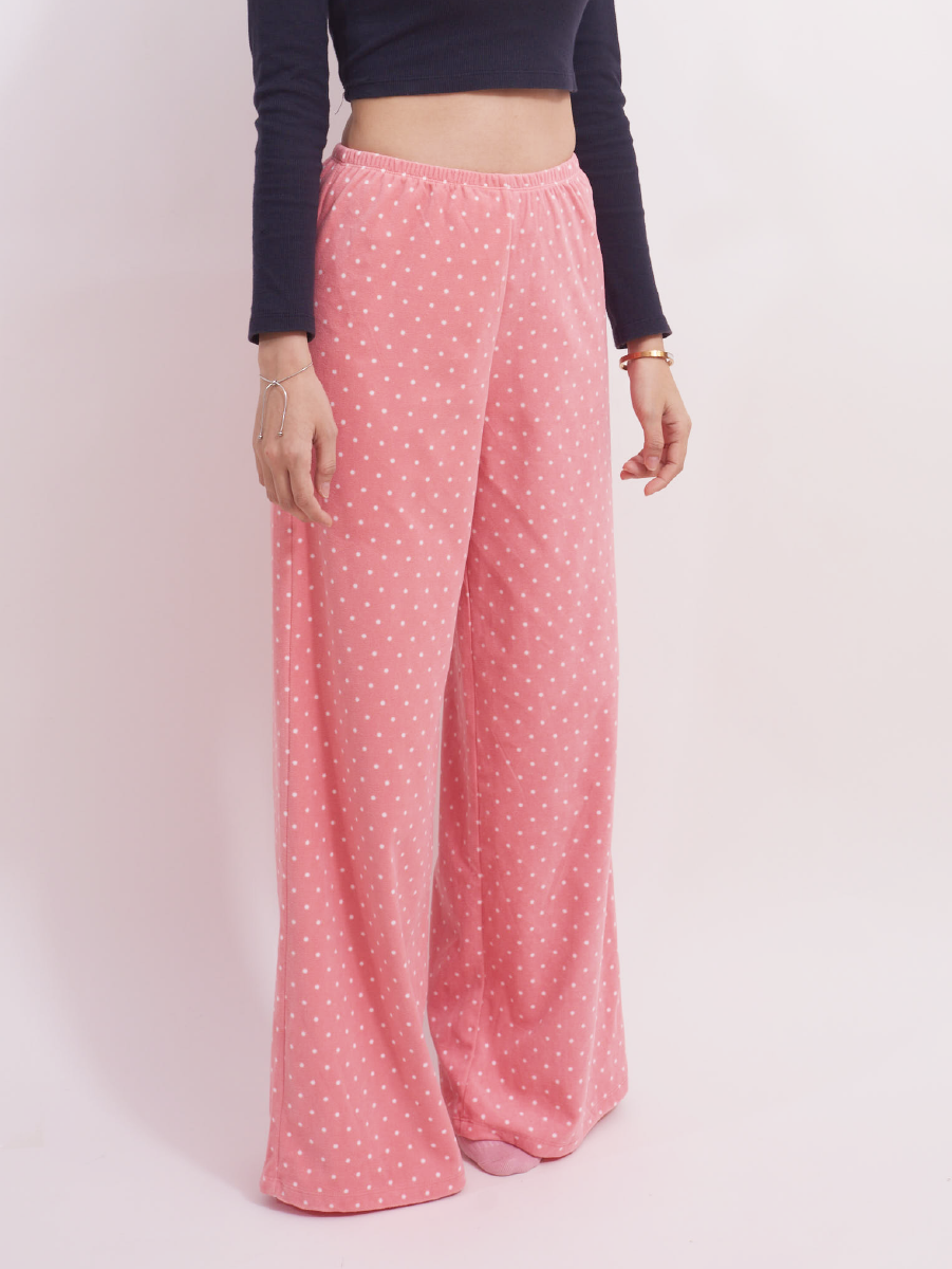 Side view of pink polka dot fleece lounge pants, high-rise and wide leg, ideal for cold weather.