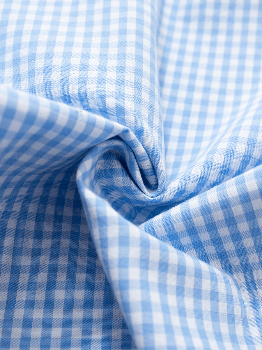 Close-up view of the blue gingham cotton fabric, showcasing its texture and pattern, used in mid-rise slim fit wide leg lounge pants.