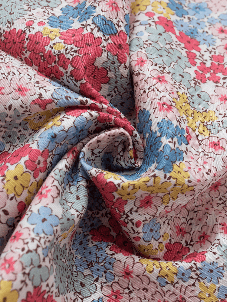 
                                            
                                                Detailed close-up of the fabric on low-rise lounge pants in a pastel pink ditsy floral print, showcasing vibrant red, blue, and yellow flowers on soft, breathable 100% cotton.
                                            
                                        