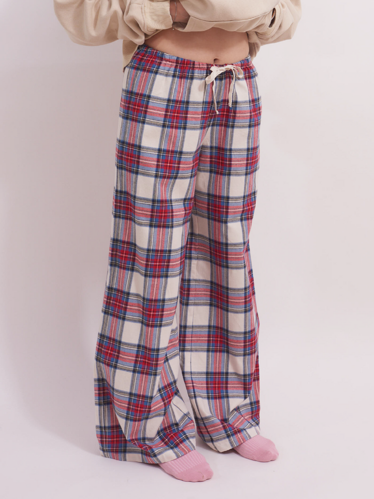 
                                            
                                                Front waist detail of low-rise wide leg lounge pants in red and cream plaid tartan, featuring a drawstring and elastic waistband for a comfortable fit, crafted from 100% brushed cotton flannel.
                                            
                                        