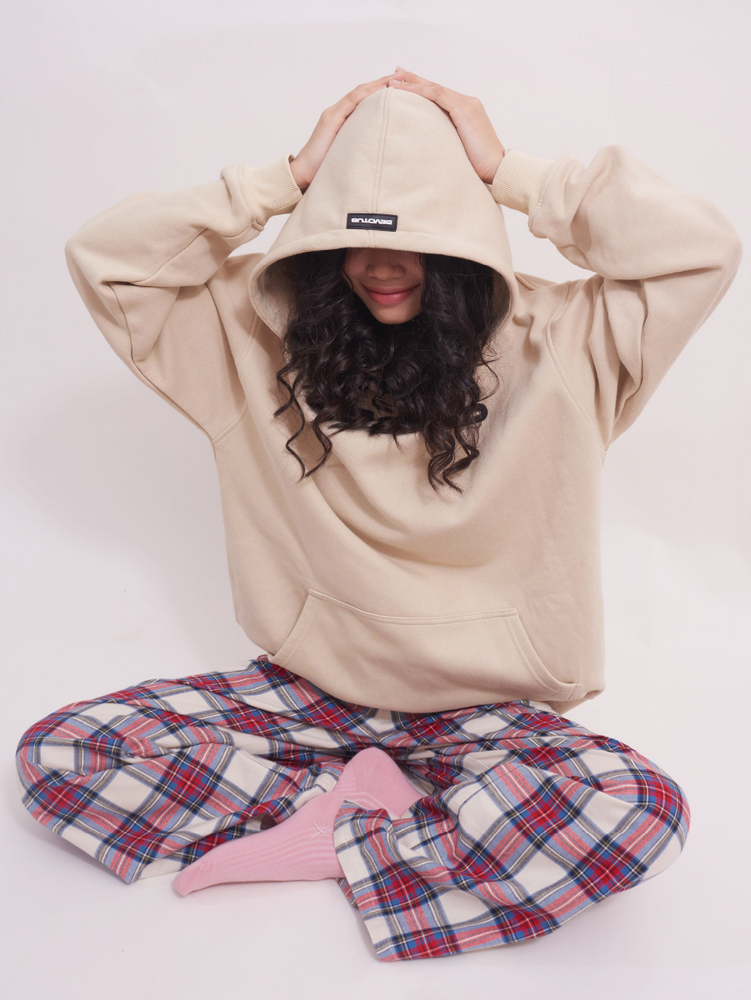 
                                            
                                                Model sitting cross-legged in low-rise wide leg lounge pants in red and cream plaid tartan, showing the relaxed fit and soft texture, ideal for casual or sleepwear.
                                            
                                        