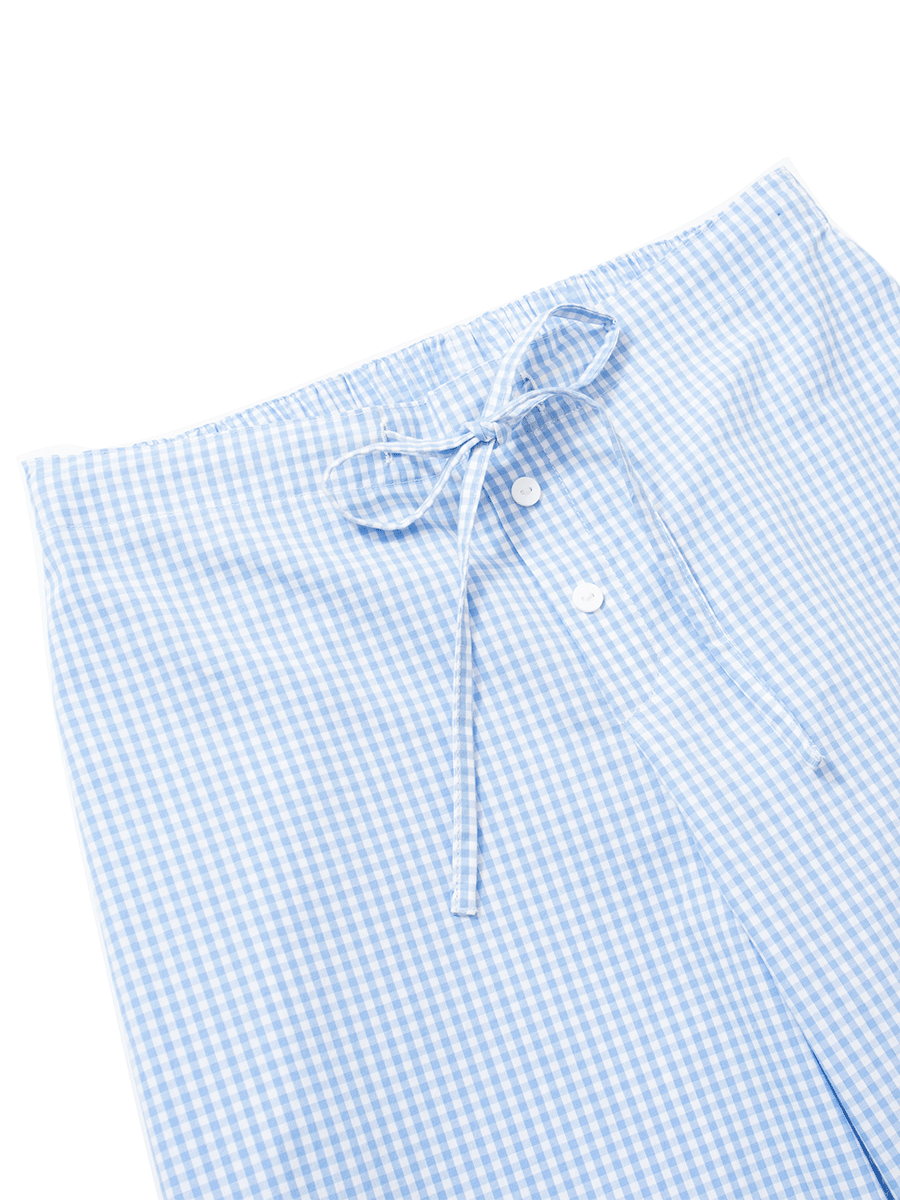 Waist detail of mid-rise slim fit wide leg lounge pants in blue gingham, featuring a mock fly with buttons, an elastic waistband, and a drawstring for added fit.