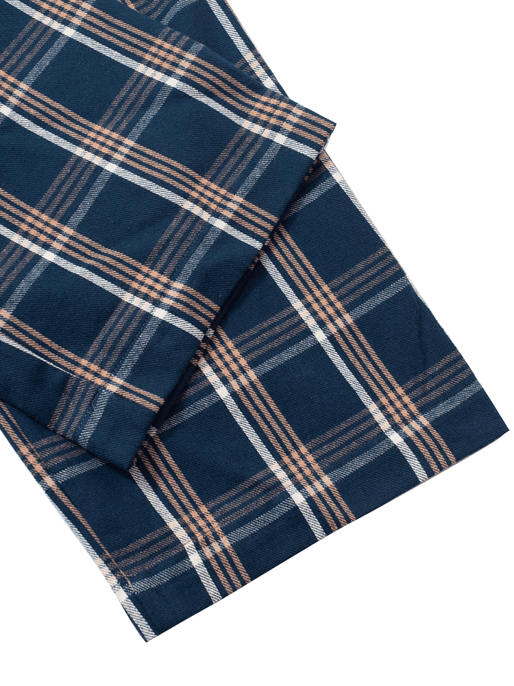 
                                            
                                                Close-up of blue plaid tartan brushed cotton fabric, ideal for warm winter pyjamas.
                                            
                                        