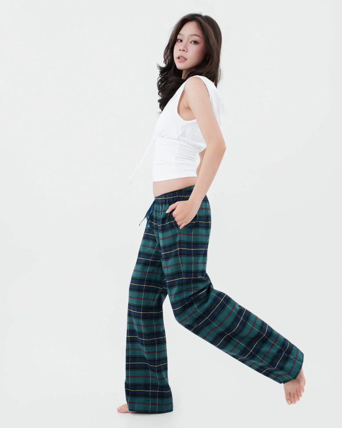 Model moving in low rise forest green tartan plaid flannel pyjama bottoms