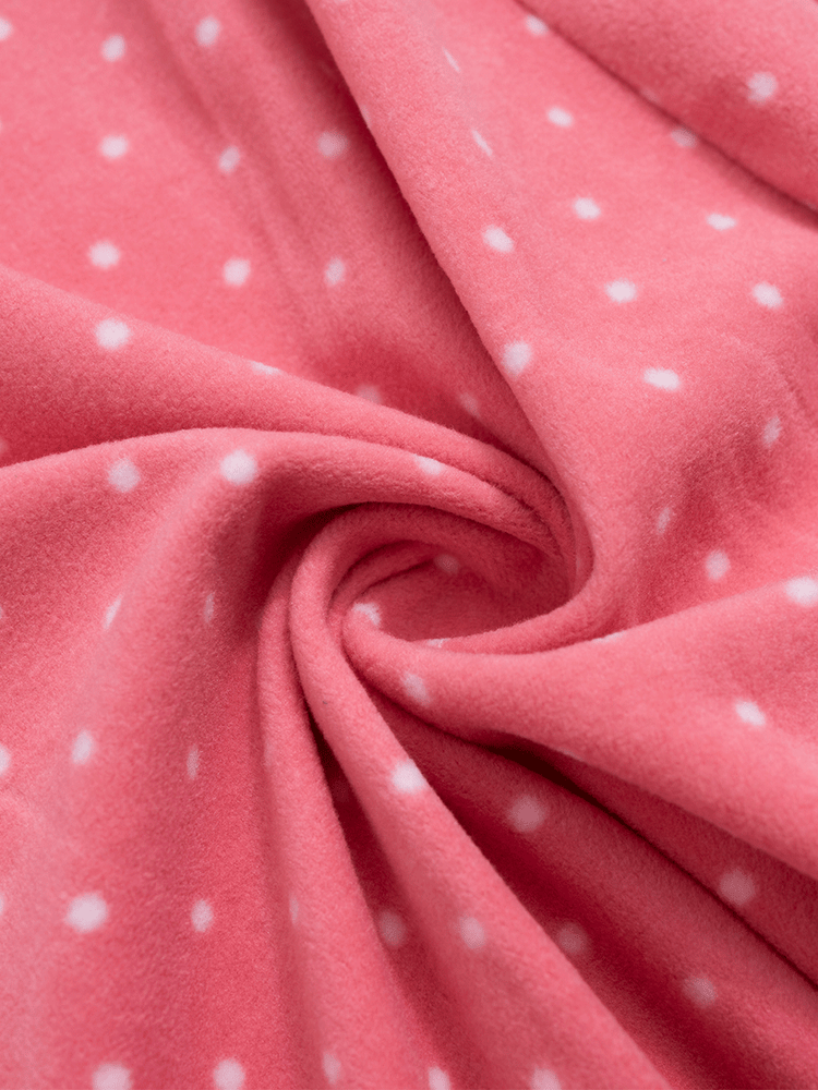 
                                            
                                                Close-up of soft, fuzzy pink polka dot fleece fabric, cosy for winter.
                                            
                                        