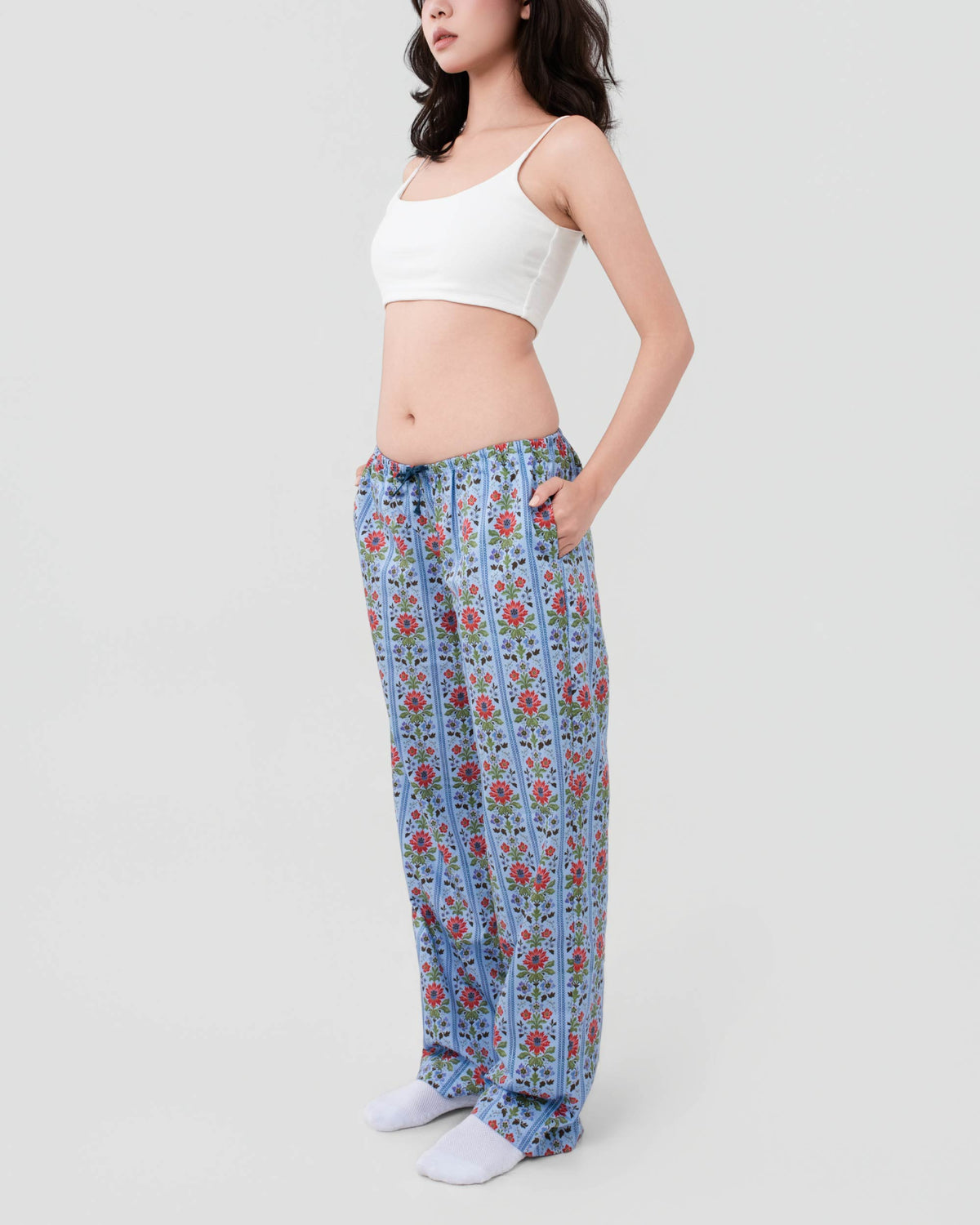 Side view of a model wearing SleepyPants Lounge Low Rise blue floral stripe cotton poplin pyjama bottoms