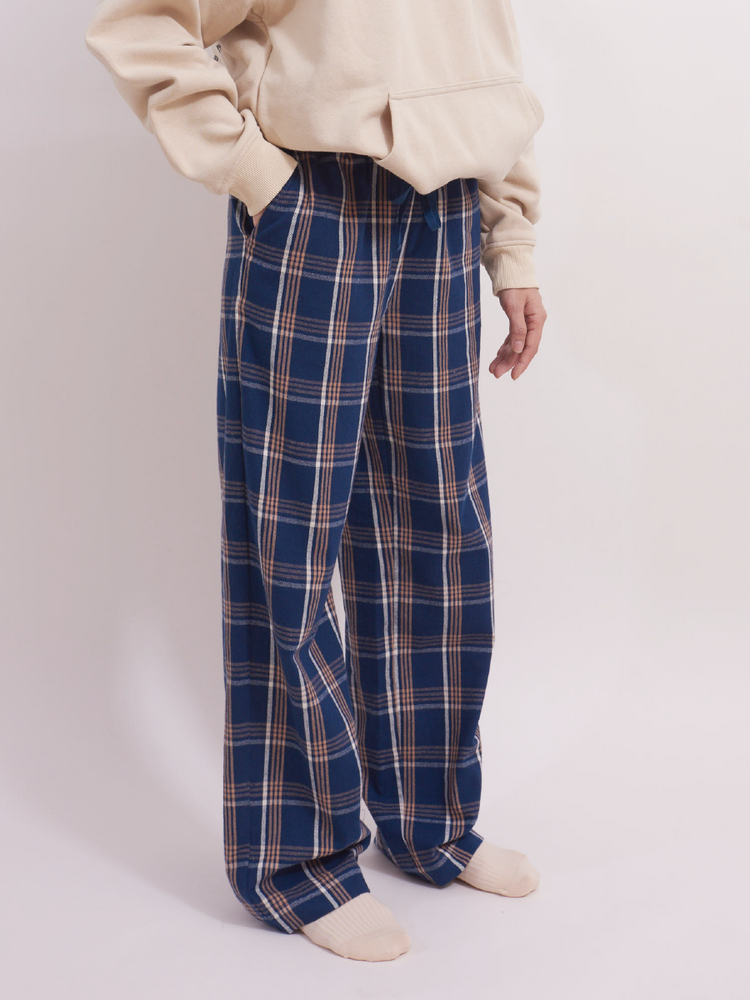 
                                            
                                                Side view of blue plaid tartan brushed cotton pyjama bottoms with pockets, warm weather pyjamas.
                                            
                                        
